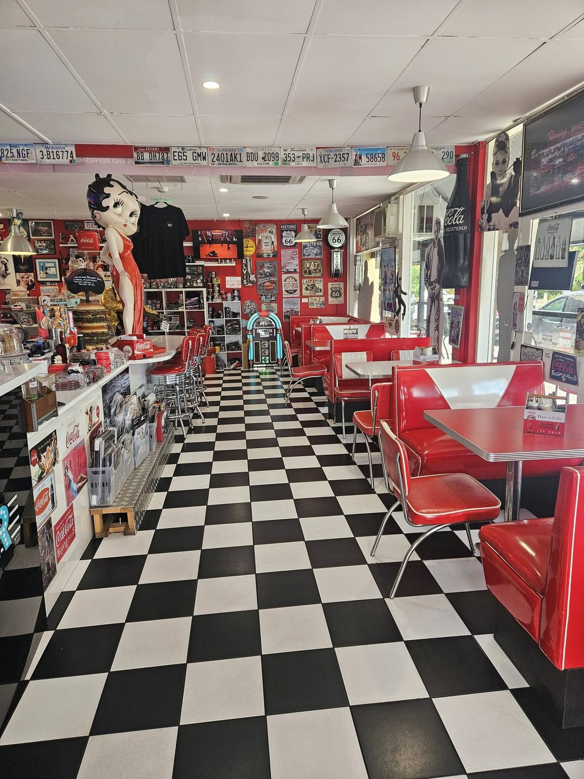 Red vinyl booths, chrome-legged tables and a checkerboard floor inside Barossa 50's Diner