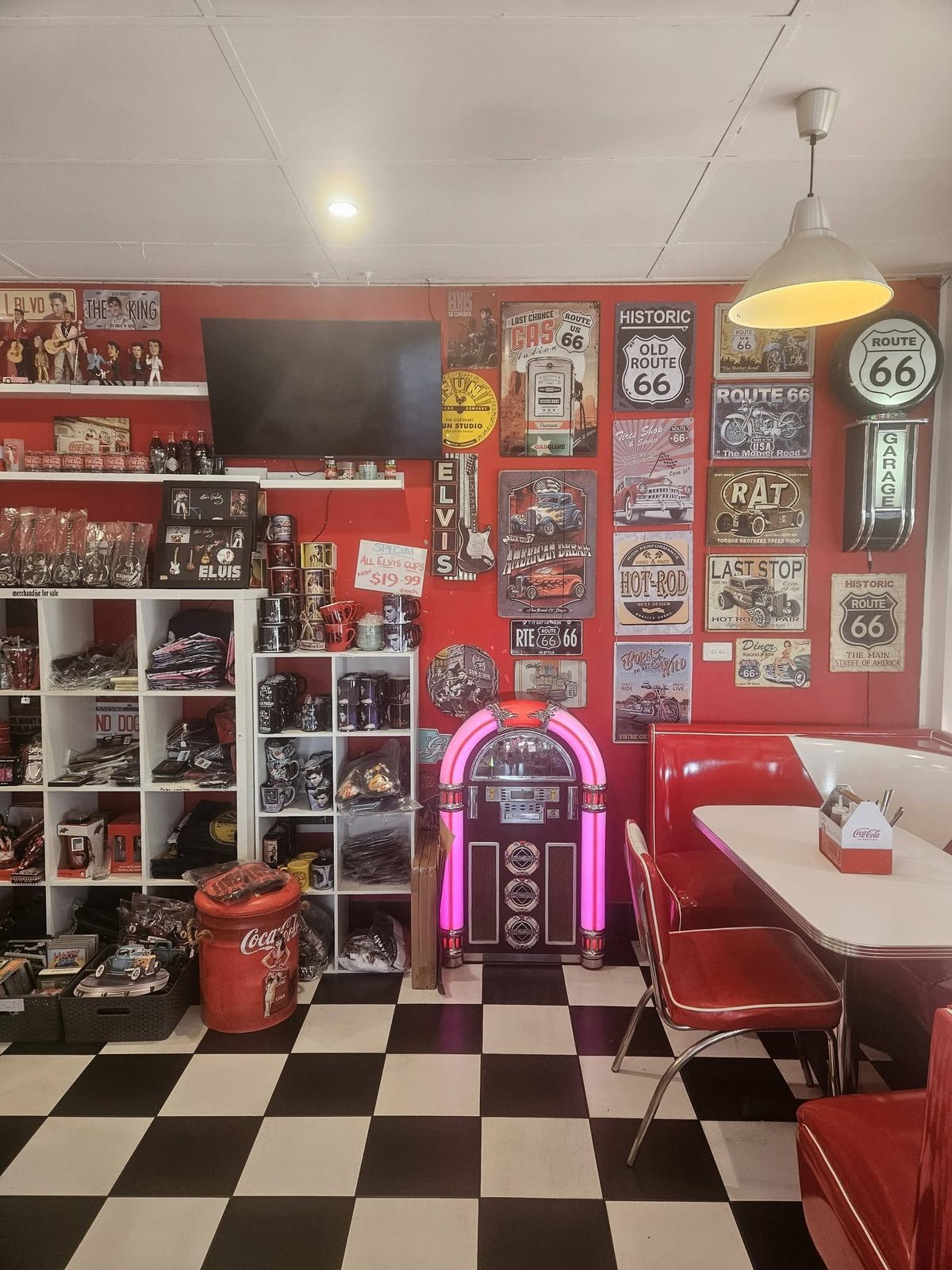 A glowing retro jukebox in the corner of the diner